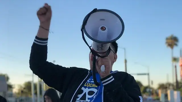Organizer marching with a megaphone. Credit: Living United for Change in Arizona (LUCHA)