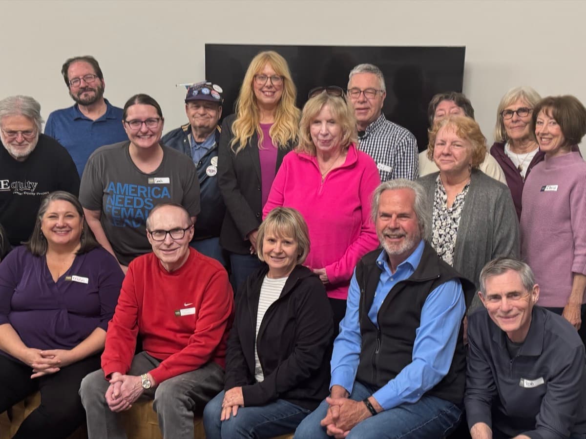 About 20 Blue Sky Waukesha members pose together indoors.