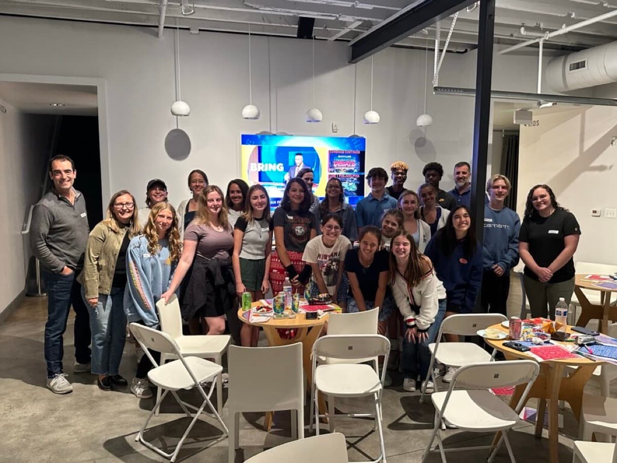 About 30 young Voters of Tomorrow members pose together indoors.
