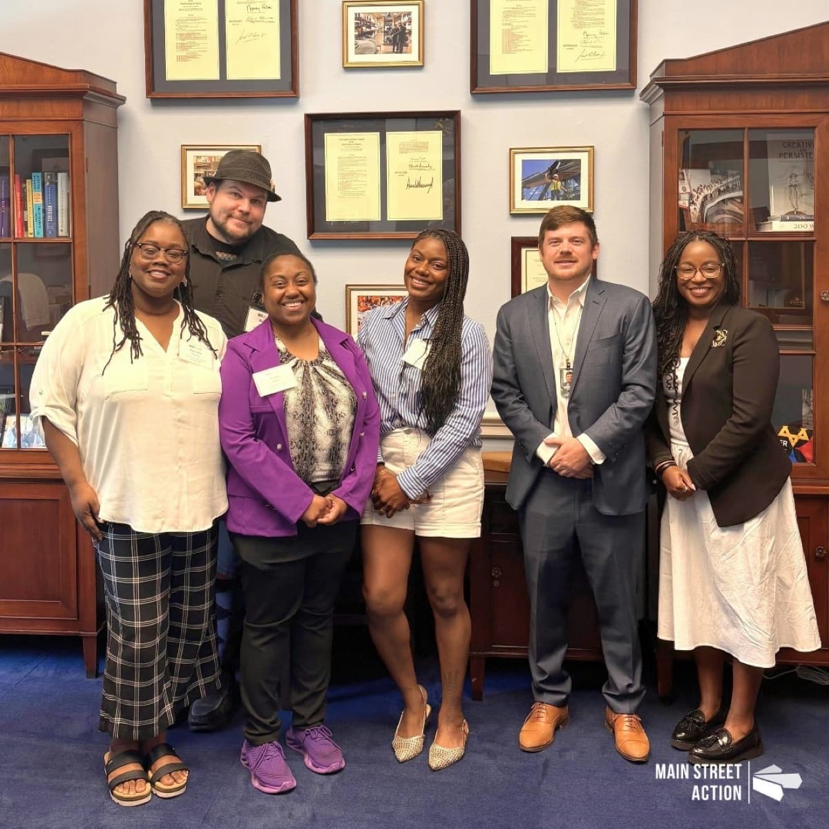 Seven Main Street Action small-business members stand together in a congressional office.