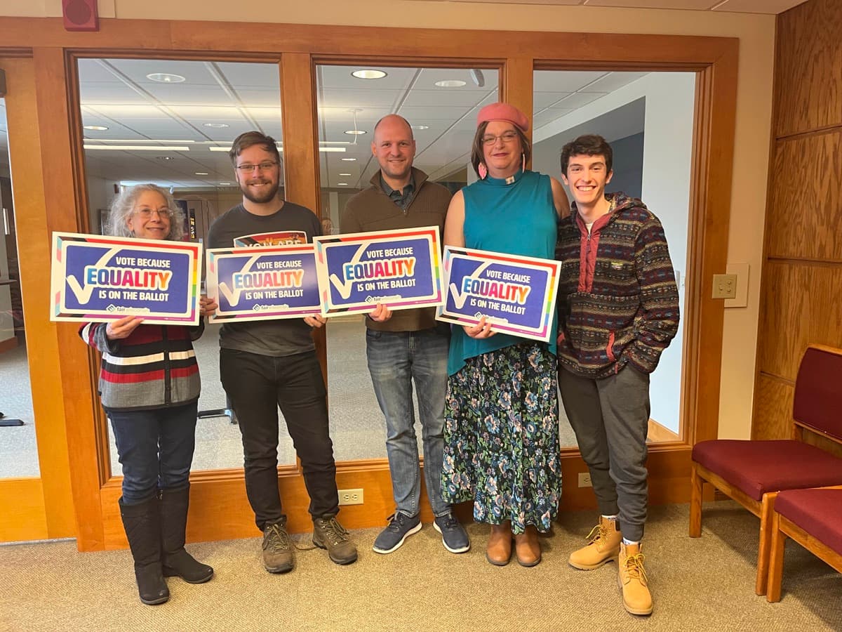 Five Fair Wisconsin supporters hold signs reading “Vote because equality is on the ballot.”