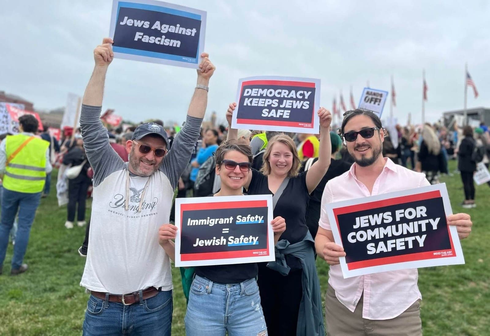 Bend the Arc members at a rally hold signs reading “Jews Against Fascism” and “Democracy Keeps Jews Safe.”