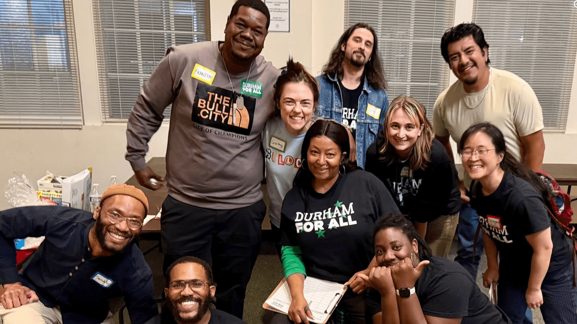Carolina Federation organizers crowd together and smile at a community meeting in North Carolina.
