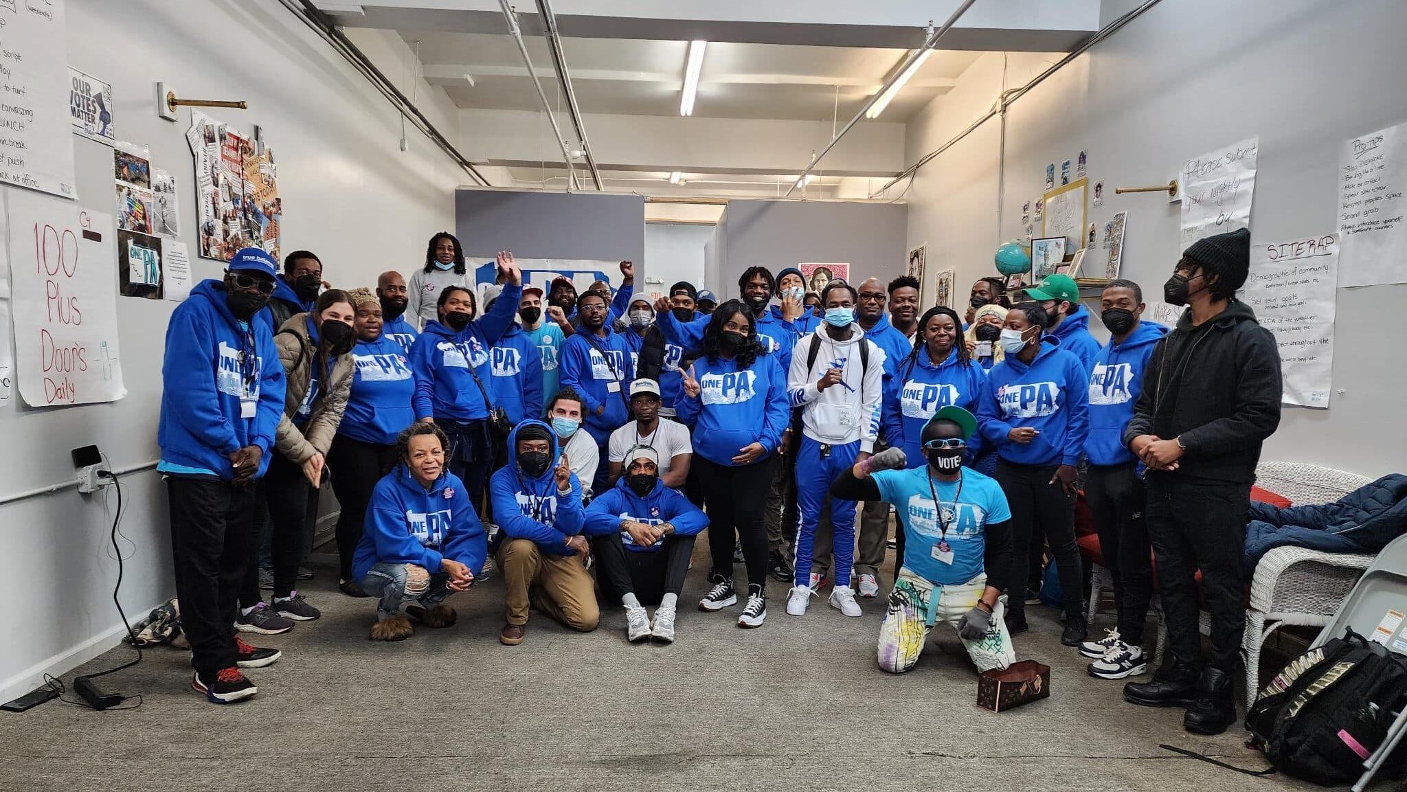 One Pennsylvania organizers in blue sweatshirts pose together indoors.