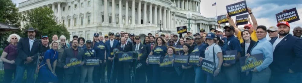 Common Defense veterans and military families gather with signs near the U.S. Capitol.