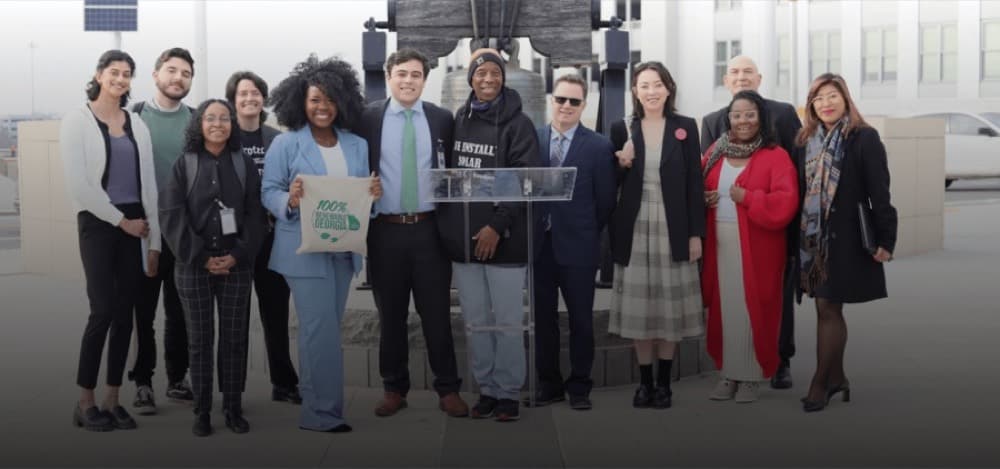 Georgia Conservation Voters leaders and allies stand together at a podium.