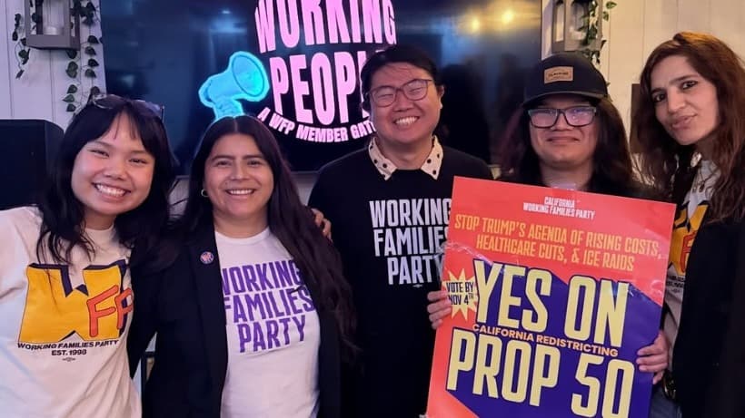 Working Families Party members pose with a “Yes on Prop 50” sign.
