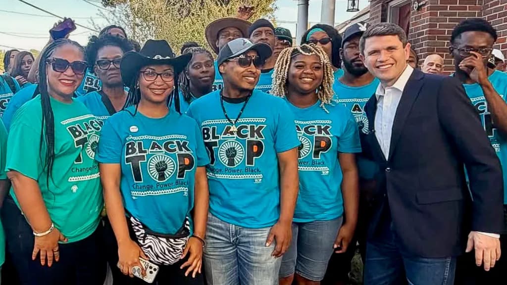Texas Organizing Project organizers in “Black TOP” shirts posing with James Talarico.