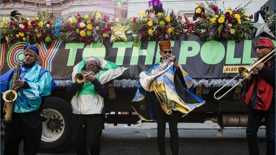 Photo: Joy to the Polls makes voting fun and joyful through a parade complete with a brass band, costumes, and dancers.